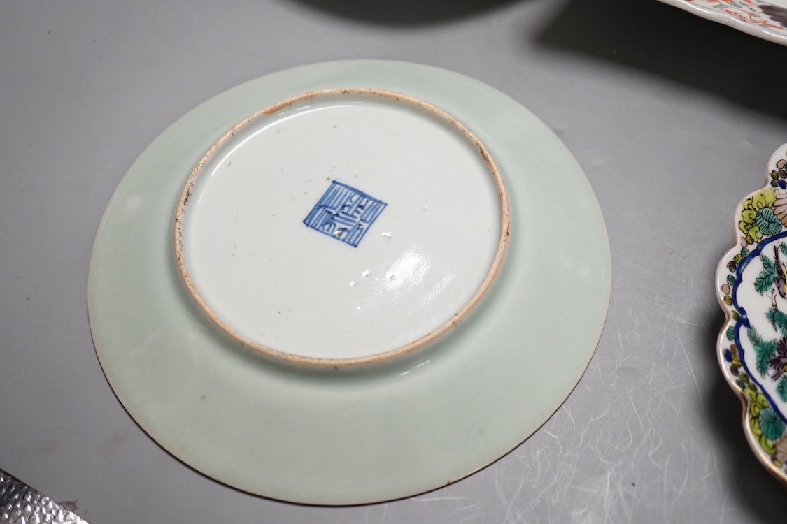 A 19th century Chinese blue and white 'prunus' vase, a Chinese green glazed jar, a japanese vase and two dishes and two Canton famille rose plates (7)